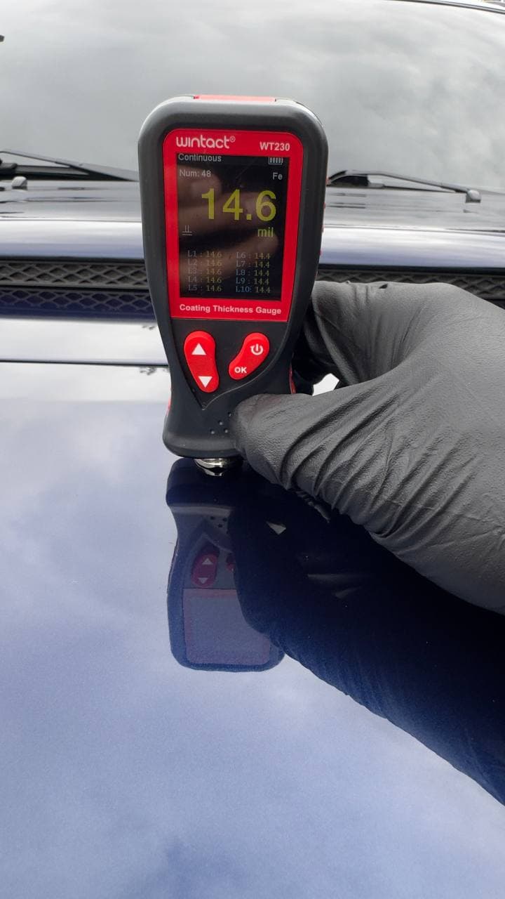 Paint thickness gauge measuring panel before water spot correction